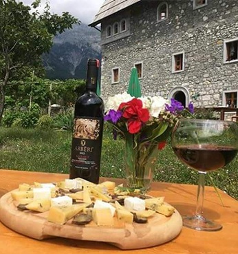 image of wine and cheese in a garden