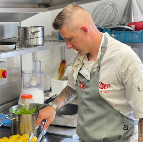 image of lee cooking in a school kitchen